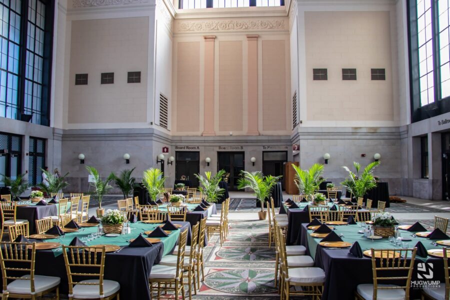 Tables and chairs set up around a room with teal decorations