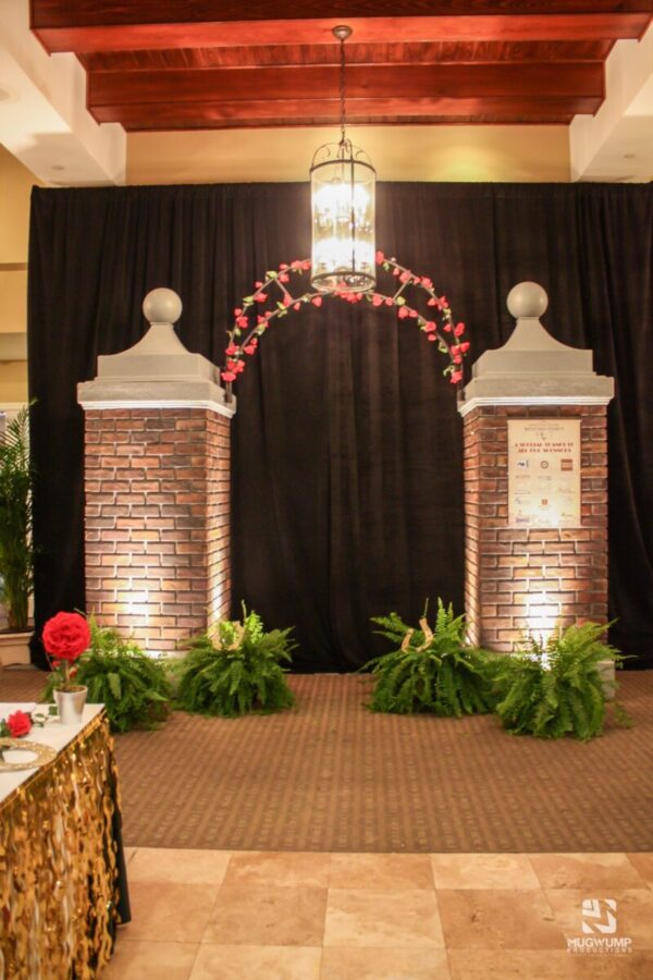 Black-Curtain-Backdrop-Photo-Booth-Brick-Floral-Arch