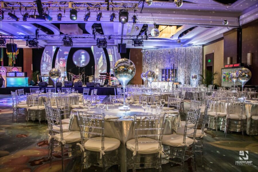 disco-1970s-themed-event-decor-clear-chairs-metalic-linens-1200x800