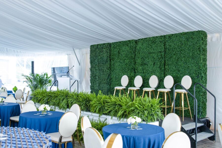 Greenery-Wall-With-White-Chairs-On-Stage