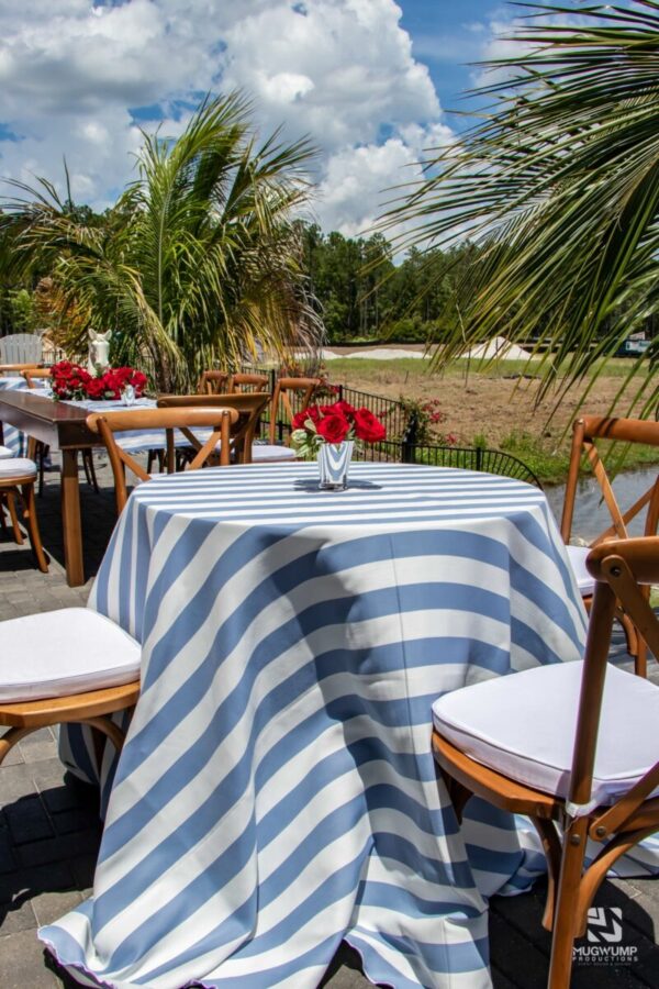 Red-Roses-Blue-Striped-Linens-Brown-Chairs